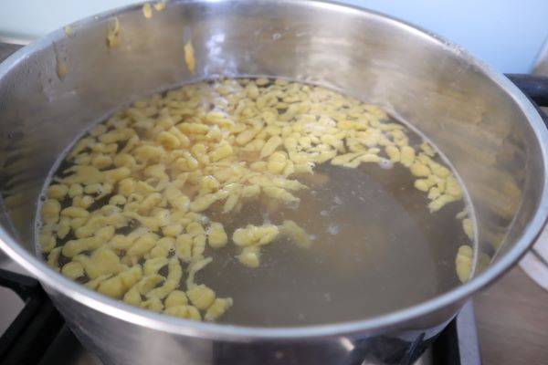 the spaetzle simmer in the hot water